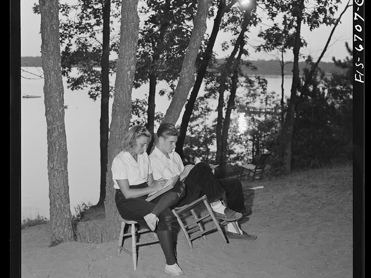 Two National Music Camp students studying together beside the lake at Interlochen in 1942.