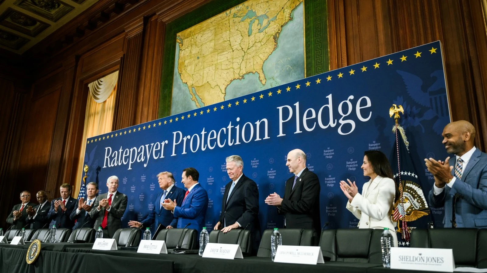 President Trump and utility and data-center representatives standing before a Ratepayer Protection Pledge backdrop.