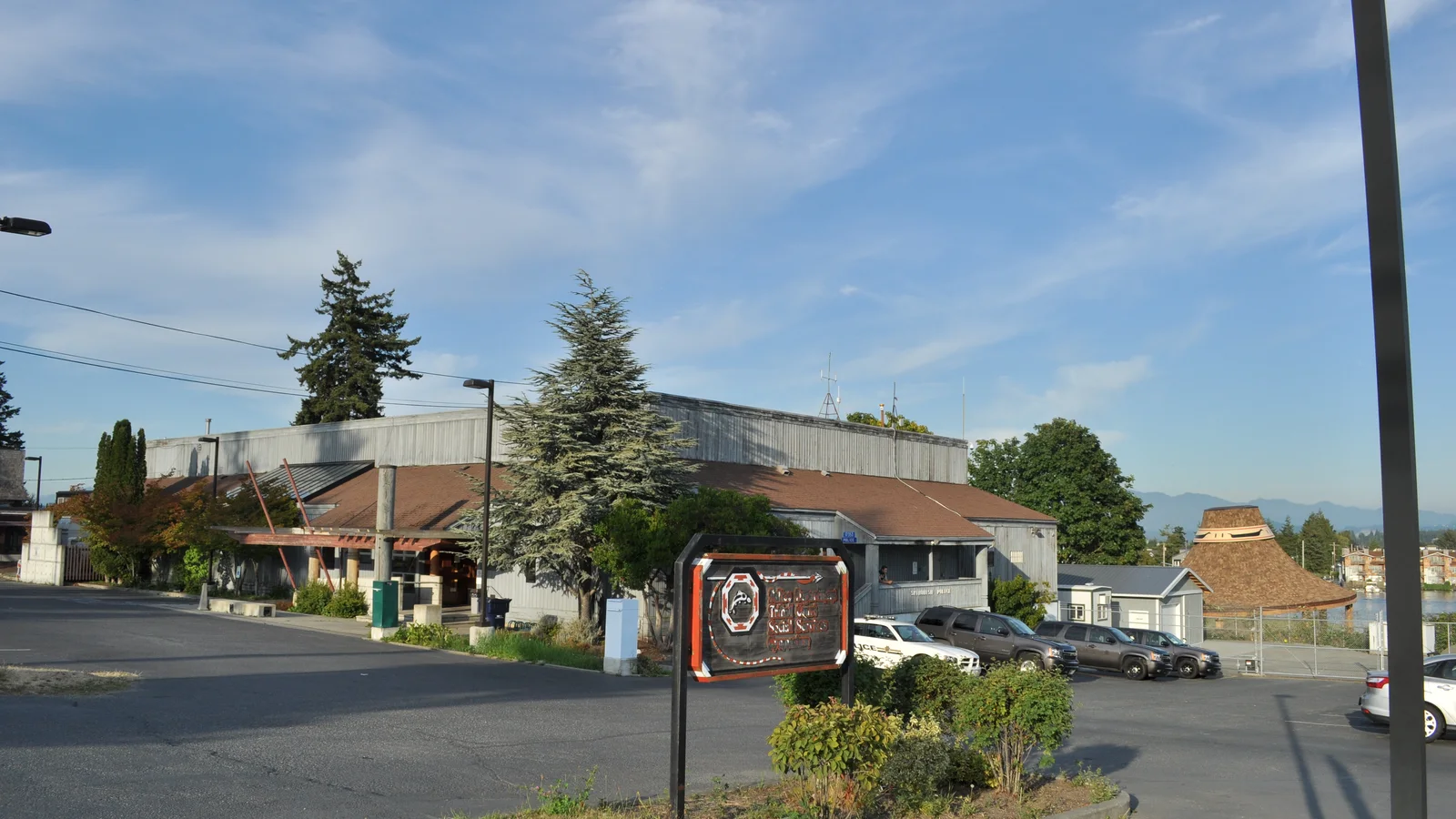 A small tribal police department building stands beneath a broad cloudy sky.