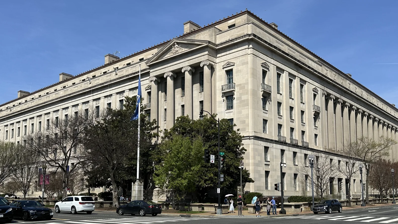 The long stone facade of the U.S. Justice Department headquarters fills a city block in Washington.